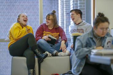 Photo: Students talking and laughing outside of class